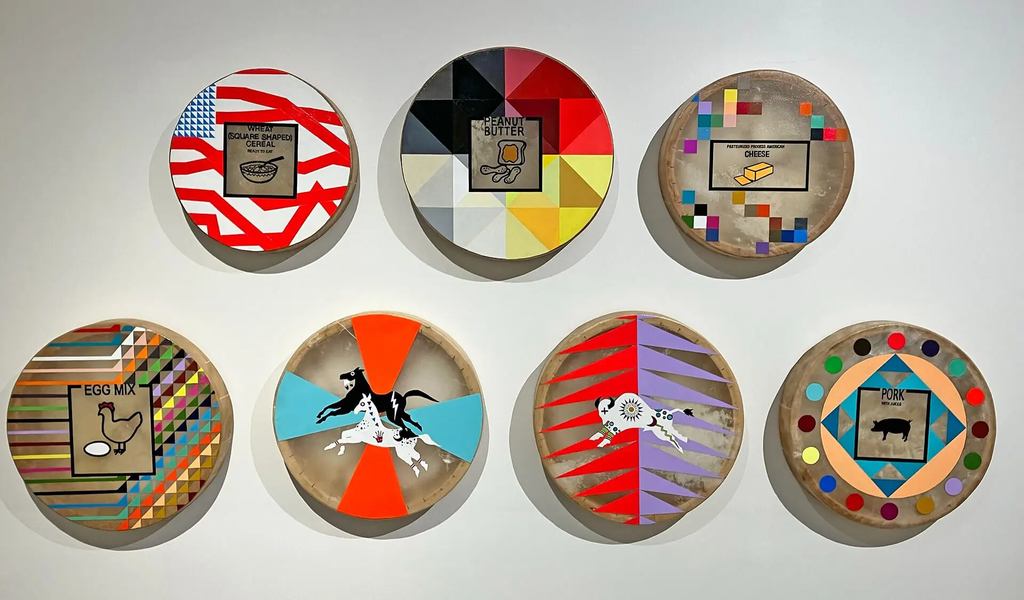 Danielle Seewalker, NDN Food Commodities series, 2023-2024, varying colors and patterns made with acrylic on buffalo rawhide. Image courtesy of Plains Art Museum.