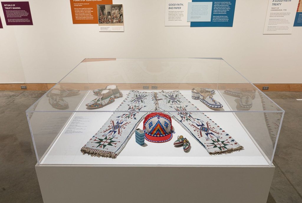 Historic and contemporary beadwork on view in Wiwahokichiyapi, several pieces in this case were donated to PAM through the Ralph T. Coe Center’s Rehoming Initiative. Image courtesy of Plains Art Museum.
