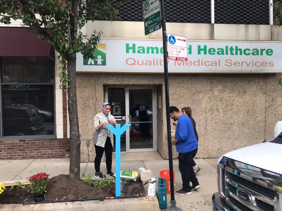 Urooj Shakeel installing Truck Art Meets Little Free Library at Devon Avenue and Clark Street, just in front of the Hamdard Health Center. Photo by Hilesh Patel.